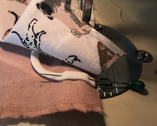 Pin the other end of the elastic to the right side of the backing fabric