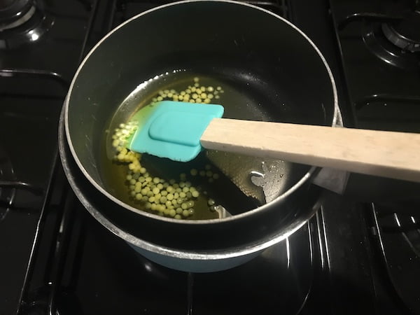 gently heat the beeswax and oil for the DIY lickable paw balm