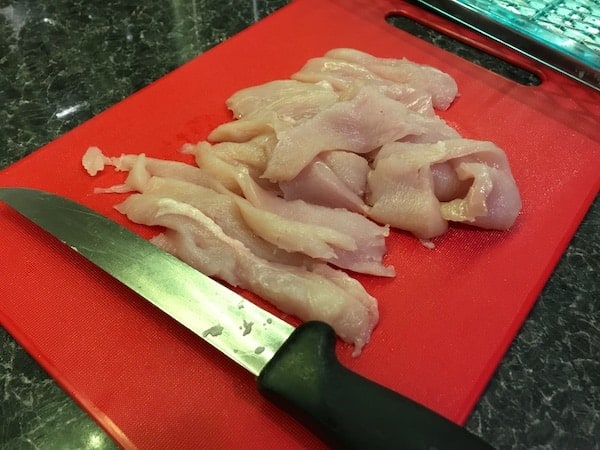 Chicken breast sliced ready to make homemade chicken jerky for dogs